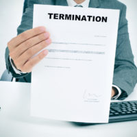 man in suit showing a figured signed termination document